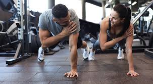 Image of man and woman doing Cardio Cheshire to tone their arms. 